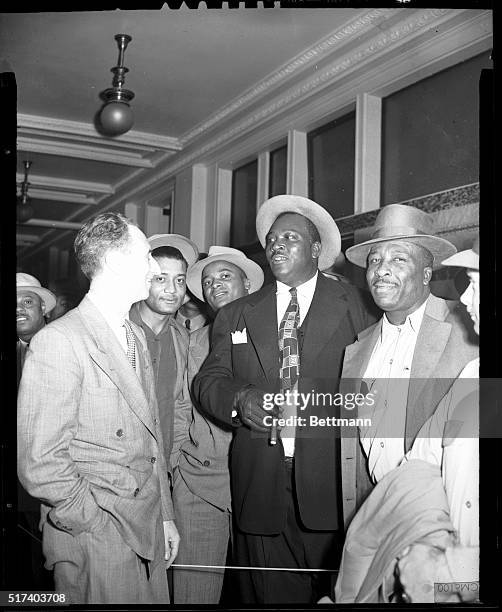 Harry Bridges is shown with a group of his longshoremen outside of Federal Court just before Bridges went on trial today. One of the men in the...