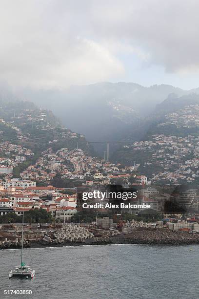 clouds over the coastline of funchal, madeira. - funchal bay bildbanksfoton och bilder