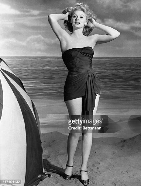 Relegating the sarong, lurong and other Hollywood "ongs" to the ashcan, this bathing suit, worn by Lucille Ball, is going to make American beaches...