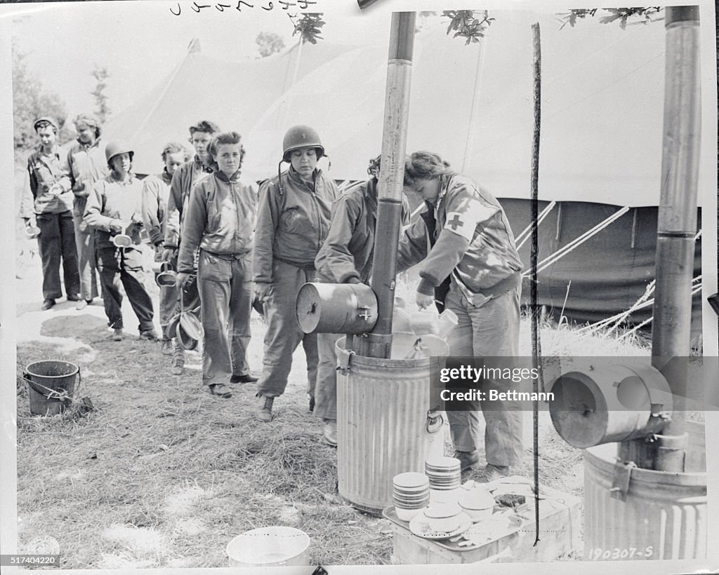 Women Standing in Line to Wash Utensils