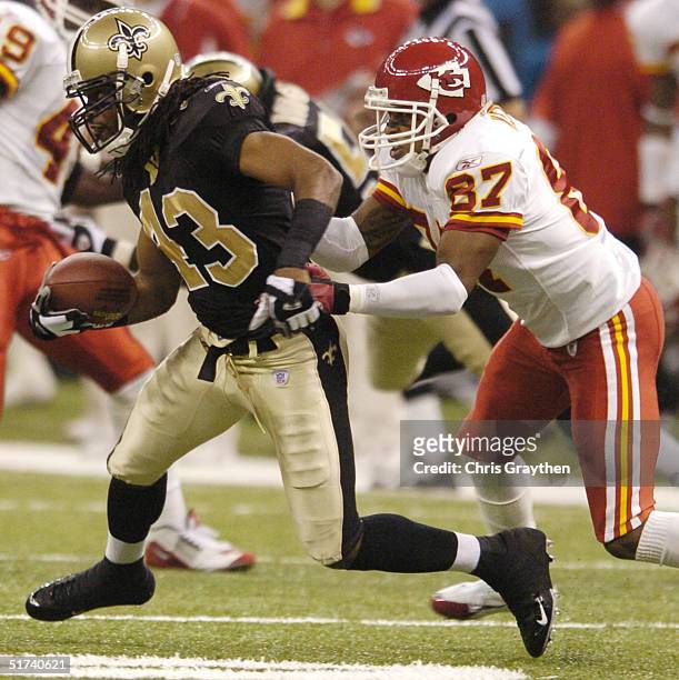 Wide receiver Eddie Kennison of the Kansas City Chiefs tackles defensive back Mike McKenzie of the New Orleans Saints after an interception at the...