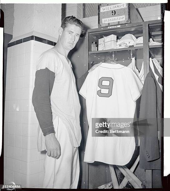 Ted Williams, Boston Red Sox star slugger, hangs up his uniform for the last time for this season, as shown here, following the game with the Detroit...