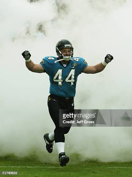 Fullback Marc Edwards of the Jacksonville Jaguars runs through smoke during player introductions prior to the start of their game against the Detroit...