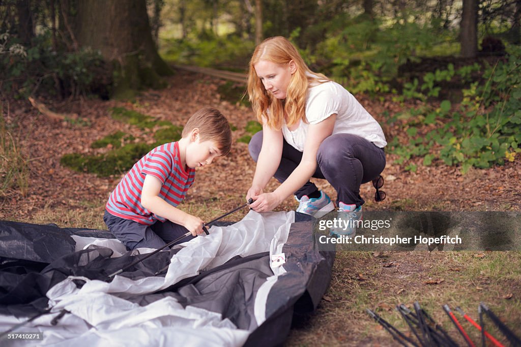 Mother and son putting up a tent