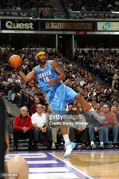 Carmelo Anthony of the Denver Nuggets hustles to save the loose ball against the Sacramento Kings on November 14, 2004 at Arco Arena in Sacramento,...
