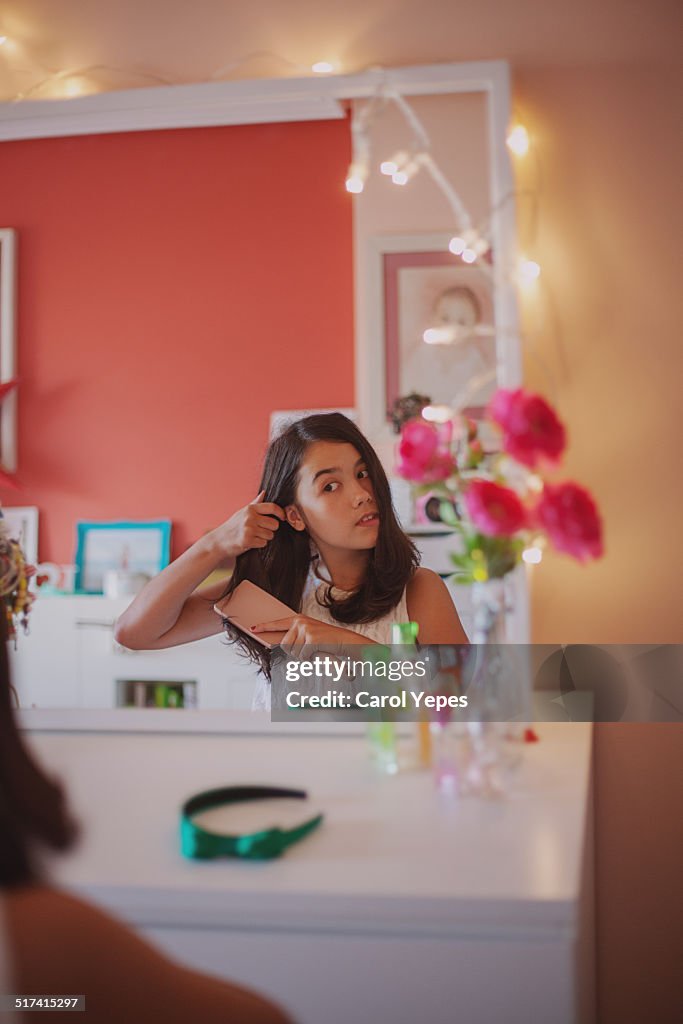 Brunette girl combing her hair