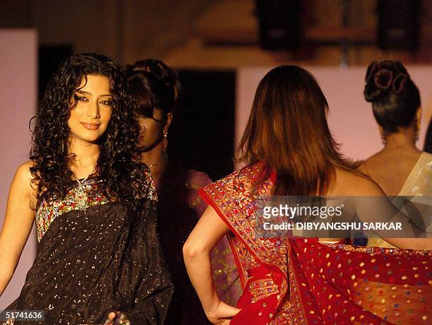 Indian models display creations by designer Erum Ali at a fashion show in Madras, late 14 November 2004. The show was organised to raise funds for...