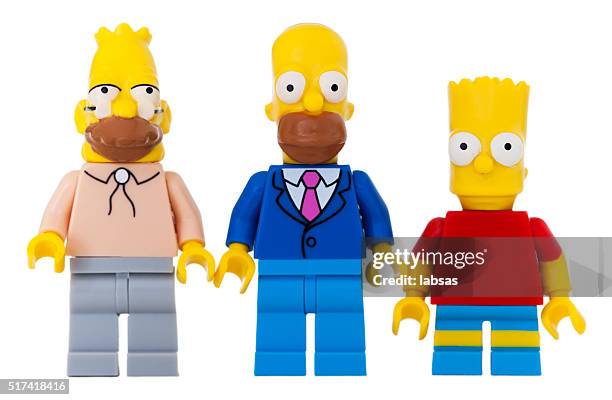 studio shot of lego mini figures, abe, homer, bart simpson. - homer simpson stock pictures, royalty-free photos & images