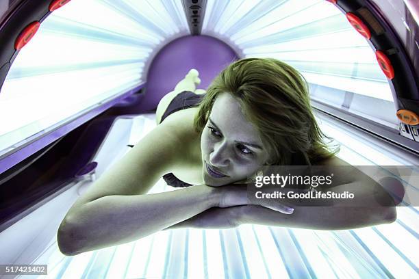 woman in solarium - sunbed stock pictures, royalty-free photos & images