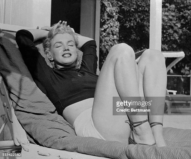 Hollywood film star Marilyn Monroe relaxes on her terrace, looking beautifully content. Actor Hugh Marlowe told the voluptuous actress that she...