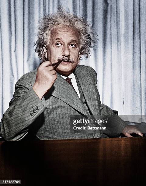 Professor Albert Einstein, now exiled from Germany, calmly smokes his pipe. He is in the United States to give a series of lectures to advanced...