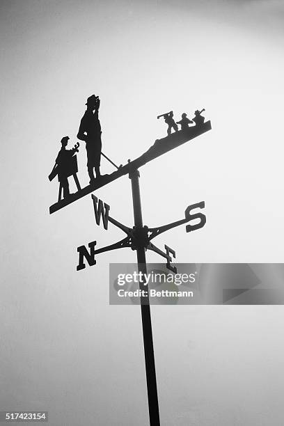 Weather vane with a golfer and caddy. Undated.