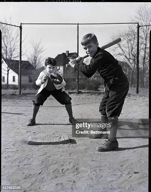 Photo shows two boys playing baseball, one at bat and one playing catch. Model: Samuel S. Walstrom, C. Byron Lear, Jr. Undated.