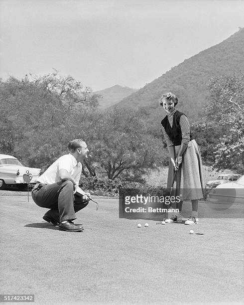 Glendale, CA: Photo shows a couple golfing at the Chevy Chase Golf Club in Glendale, CA. Models: Miss Stephany McElroy and Mr. Cotton Beavers, golf...