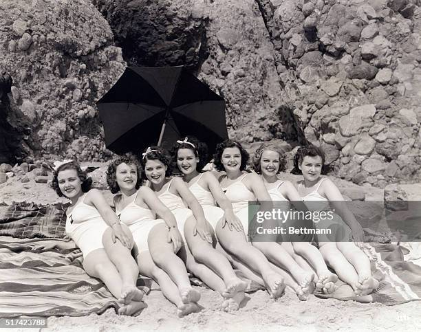 For the Z.Z. Girls. In other words, seven girls at the beach spell glorified Ziegfeld girls to those who know. Here they are in mass formation at the...