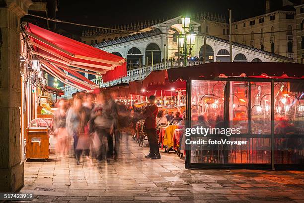 venice busy restaurants illuminated at night beside rialto bridge italy - waterfront dining stock pictures, royalty-free photos & images