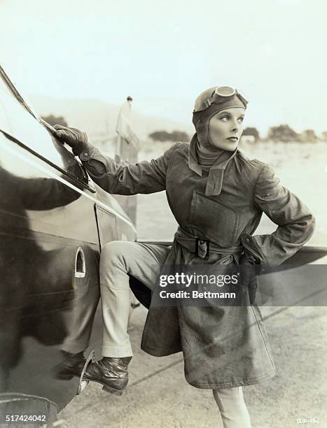 Actress Katharine Hepburn standing next to an aircraft for the film Christopher Strong.