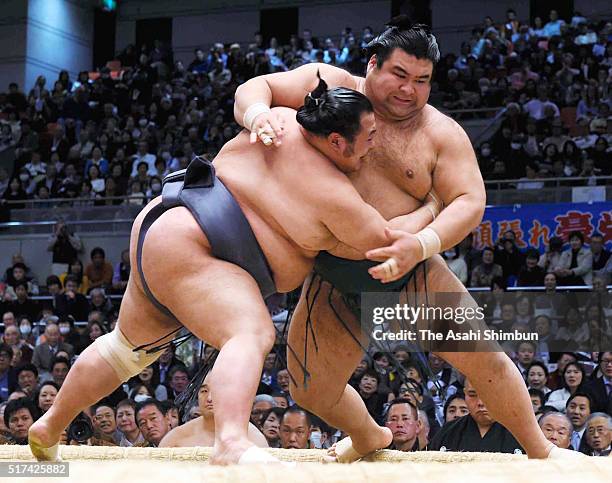 Toyonoshima pushes Takayasu out of the ring to win during day twelve of the Grand Sumo Spring Tournament at the Edion Arena Osaka on March 24, 2016...