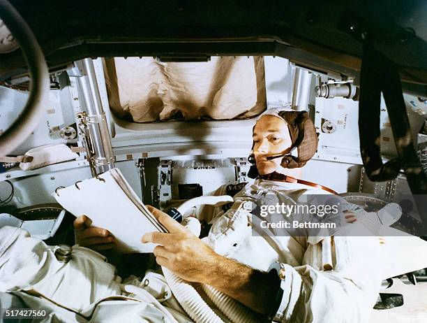 Apollo 11 training...Astronaut Michael Collins, command module pilot of the Apollo 11 lunar landing mission, studies flight plan during simulation...