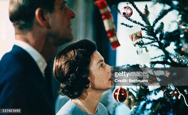 Christmas at Windsor Castle is shown here with Queen Elizabeth II and Prince Philip shown putting finishing touches to Christmas tree, in a photo...