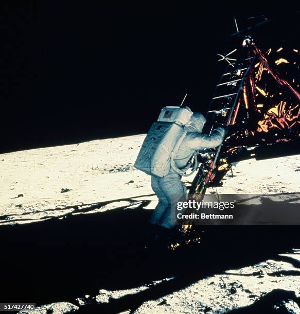 Astronaut Buzz Aldrin descends from the Eagle lunar module onto the surface of the Moon during the Apollo 11 mission. The photograph was taken by...