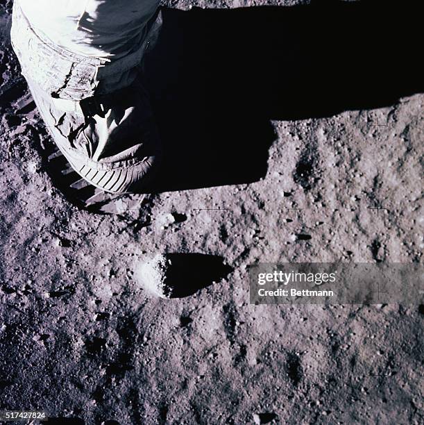 Tranquility Base, the Moon: Apollo 11 commander Neil Armstrong, first man in history to walk on the moon, plants his boot in the lunar surface during...