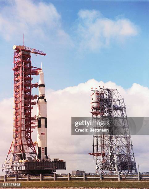 Kennedy Space Center, Fla. The Apollo 12 space vehicle and mobile launcher passes the 402 foot Mobile Service Structure during roll-out, to the...