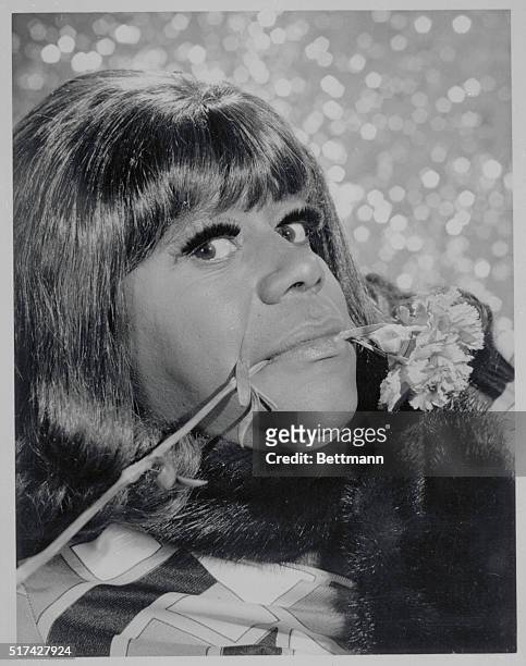 Comedian Flip Wilson dressed as woman holding a carnation in his mouth, during the premiere of the TV show, The Flip Wilson Show.