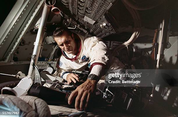 Captain Richard Gordon works on equipment of the Apollo 12 command module, in preparation for the November 14 mission.