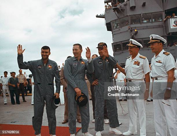 Aboard the Iwo Jima: Apollo 13 astronauts wave aboard Iwo Jima, aircraft carrier, after splashdown in Pacific . Left to right: Fred W. Haise, LM...