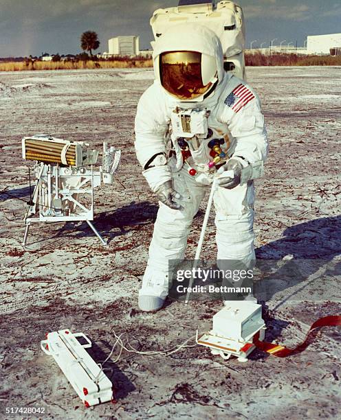 Kennedy Space Center, Fla.: Apollo 13 Spacecraft Commander James A. Lovell, Jr. Prepares to assemble lunar drill during a practice Moon-walk. The...