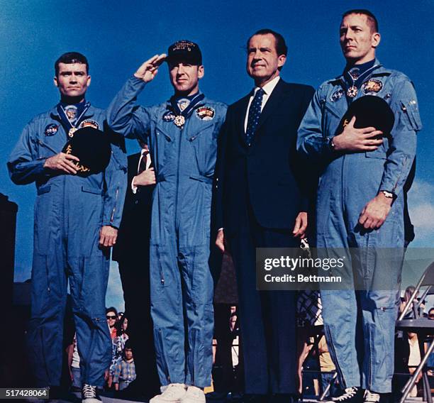 Honolulu, Hawaii: The Apollo 13 astronauts join President Nixon during playing of National Anthem at ceremonies here. The astronauts : Fred Haise,...