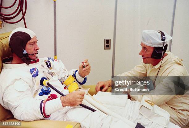 Kennedy Space Center, Florida: Apollo 14 Lunar Module pilot Edgar D. Mitchell speaks with a spacesuit technician during suiting activities preceding...