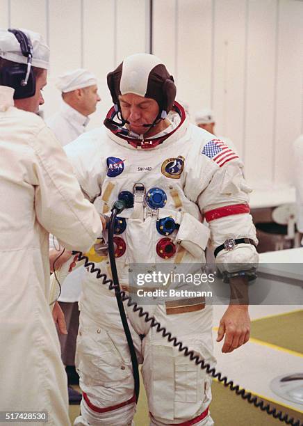 Kennedy Space Center, Florida: Apollo 14 Commander Alan Shepard watches a technician conduct spacesuit checks today prior to his participation in the...