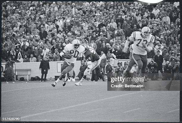 Norman, Oklahoma: Johnny Rodgers of Nebraska runs away from Ray Hamilton of Oklahoma as Dick Rupert prepares to block for Rodgers up field.