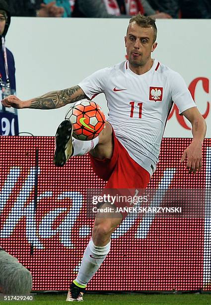 Poland's Kamil Grosicki plays the ball during the international friendly football match against Serbia on March 23, 2016 in Poznan.