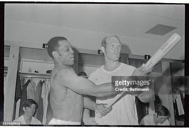 San Francisco star Willie Mays shows what makes a baseball move to Pittsburgh steeler quarterback Terry Bradshaw, in the Giant dressing room prior to...