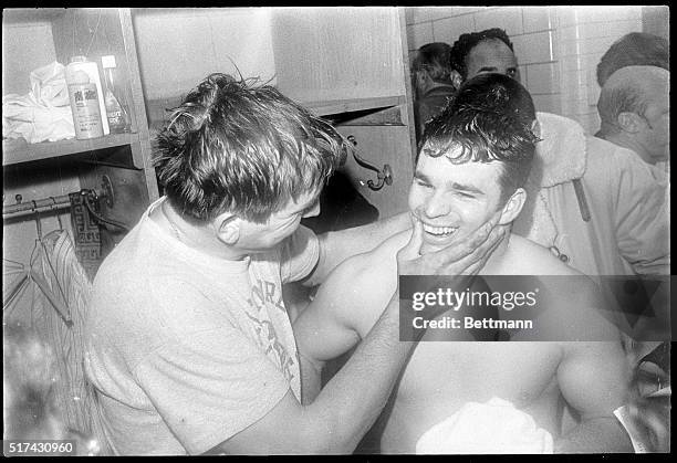 Baltimore Colts' quarterback Johnny Unitas places his arm around running back Don Nottingham after defeating Cleveland, 20-3, in the AFC playoff...