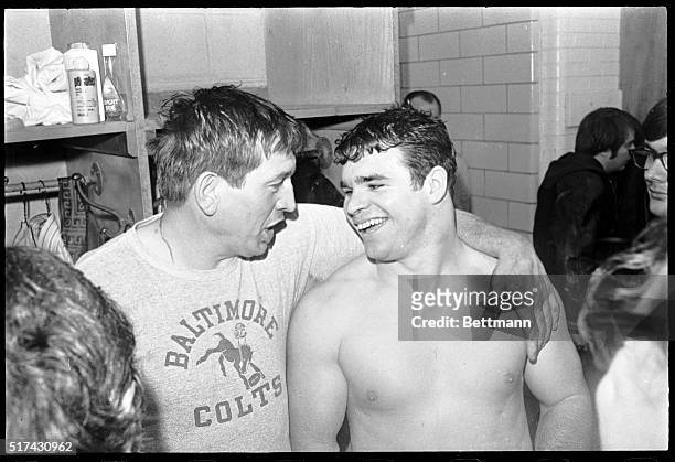 Baltimore Colts' quarterback Johnny Unitas gently pats the face of running back Don Nottingham after defeating Cleveland, 20-3, in the AFC playoff...