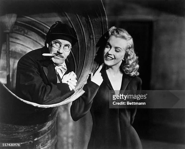 Groucho Marx and Actress Marilyn Monroe in a scene from movie Love Happy 1949.