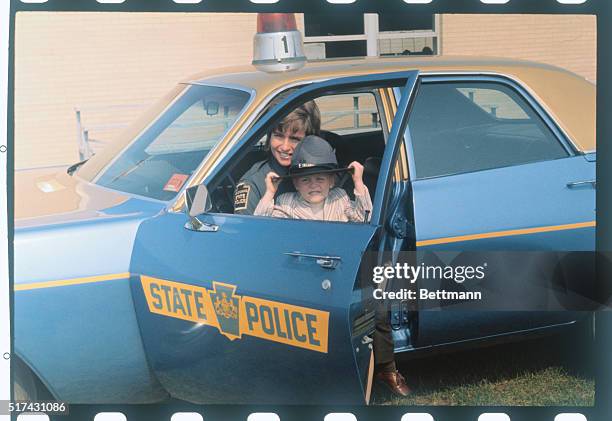 State Trooper Mrs. Lucinda Hammond of Bellefonte, Pa., is just starting her duties and already she has a problem: her son, Tom, 3-1/2, doesn't want...