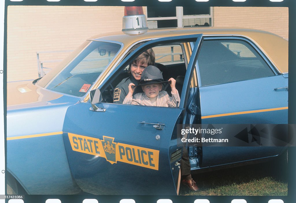 Female State Trooper with Son in Patrol Car