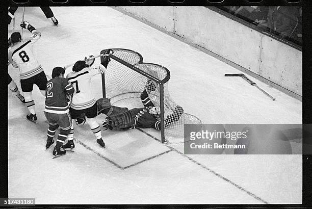 New York Rangers-Bruins-NHL Playoffs-Boston: Minus his goalie stick, Rangers' netminder Ed Giacomin falls into net as puck is fired past his head by...