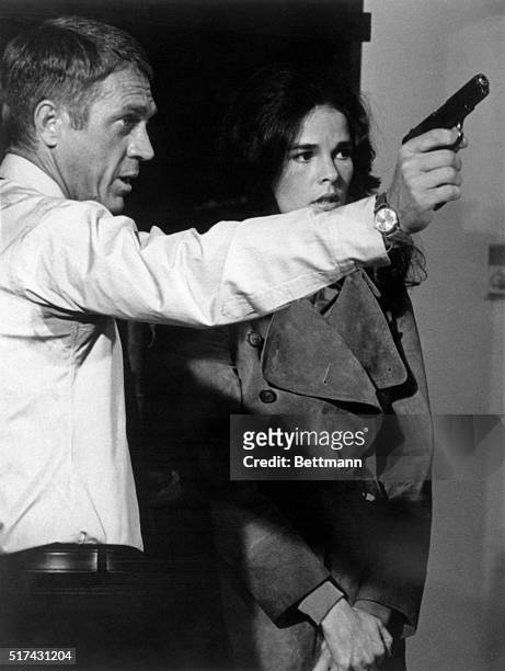 Ali's a "killer"... Steve McQueen shows Ali MacGraw how to handle a gun in San Marcos during filming of The Getaway. Ali spent about six weeks...