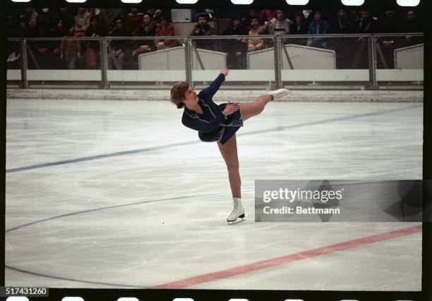 In a graceful full length action shot and wearing a blue costume, Austria's Trixi Schuba is performing in competition at the XI Winter Olympic Games...