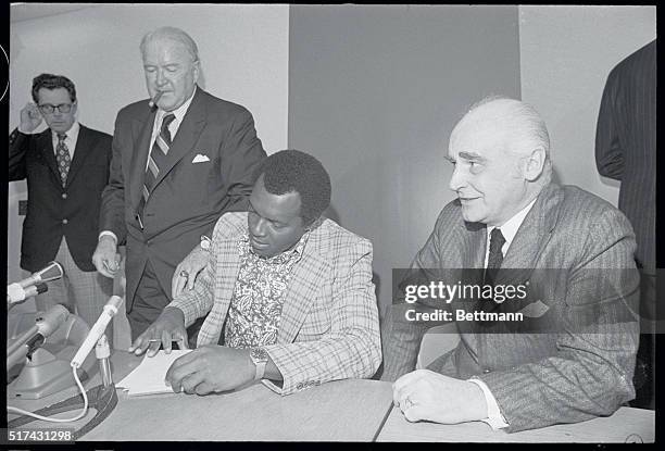 President of the American League, Joe Cronin , watching Vida Blue sign $63,000 contract. Oakland A's owner Charles Finely is at right.