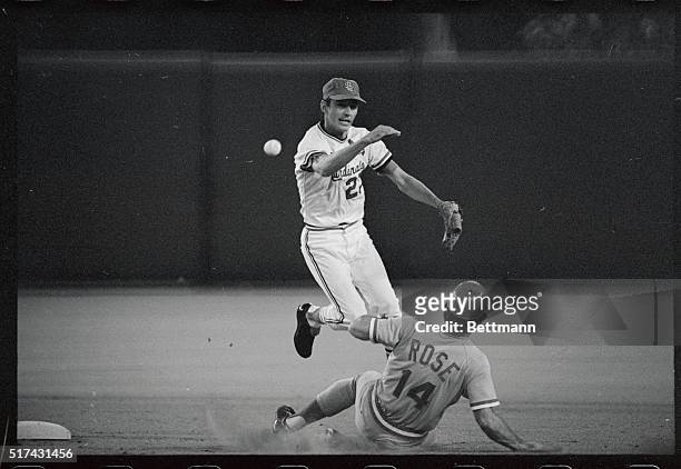 St. Louis Cardinals' SS Dal Maxvill hurries his throw as he leaps out of the way of sliding Cincinnati Reds' Pete Rose in the seventh inning of...