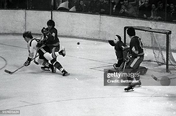 Bruins' Bobby Orr is upended by Sabres' Al Hamilton and loses puck during rugged first period action, afternoon game, Boston Garden 2/12.