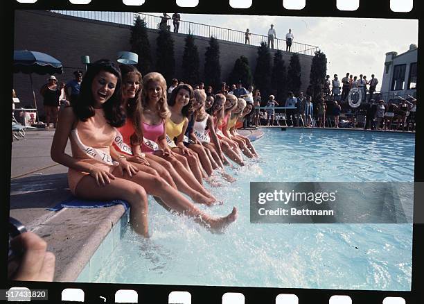 Perfect decorative embellishments for any swimming pool are these Miss America contestants, wetting their feet prior to the crowning of the winner...