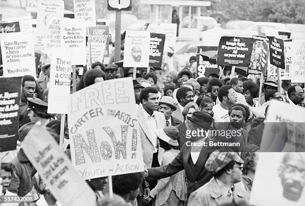 World heavyweight champ Muhammad Ali leads a rally of some 1,000 persons through streets of Trenton here, to urge New Jersey Governor Brendan Byrne...